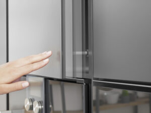 Woman's hand opening the cabinet door