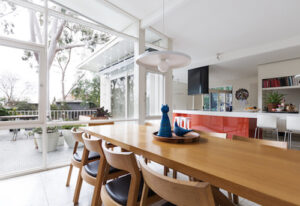 Scandinavian styled dining room and open plan kitchen with patio outlook