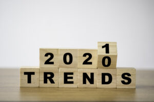 flipping 2020 to 2021 trends print screen on wooden block cubes. New idea business fashion popular and relevant topics.