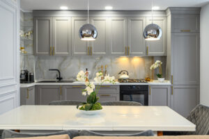 Grey and white contemporary classic kitchen interior with dining table designed in modern style, front view